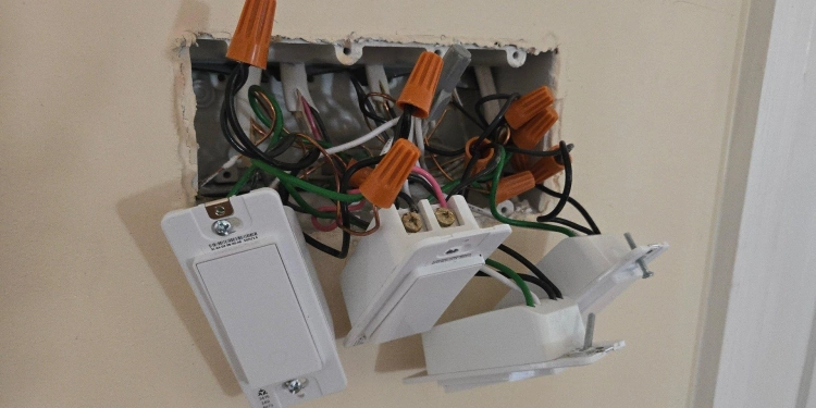 Four tapo smart switches hanging out of a wall