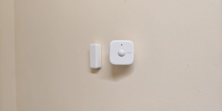 Switch Bot Presence Sensor next to a SwitchBot Thermo-Hygrometer.
