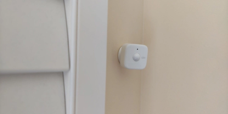 SwitchBot presence sensor next to a window shutter.