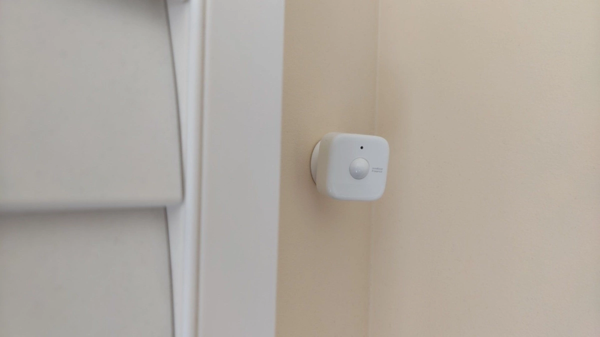 SwitchBot presence sensor next to a window shutter.