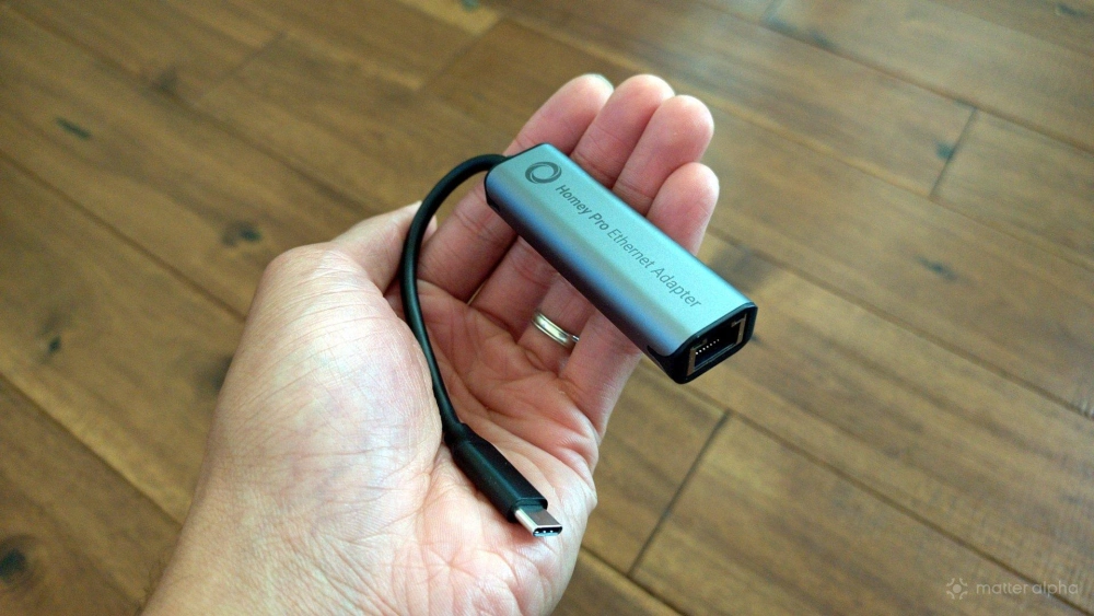 Hand holding a homey pro ethernet adapter