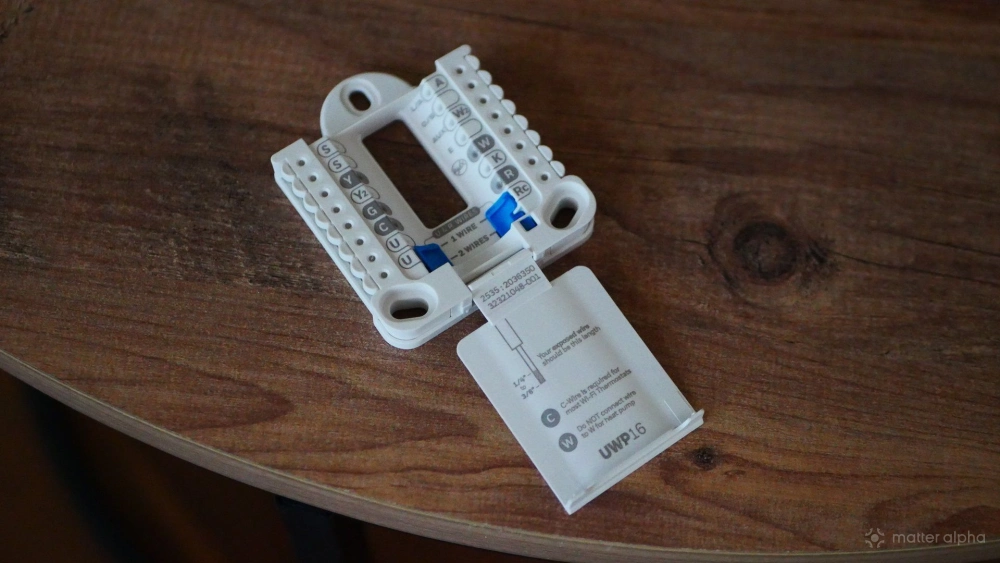 Honeywell Home UWP wall plate lying on a table.