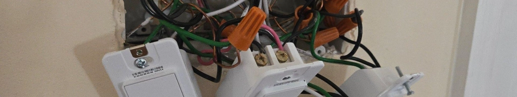 Four tapo smart switches hanging out of a wall