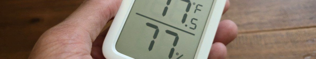 Hand holding a switchbot meter plus
