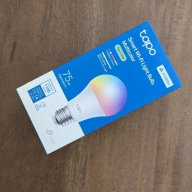 A tapo l535e smart bulb on a table