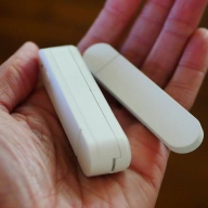 Hand holding an ikea myggbett door and window sensor