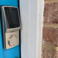 Lockly secure plus smart lock on a blue door
