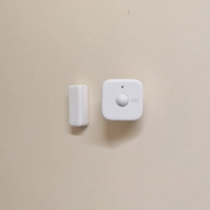 Switch Bot Presence Sensor next to a SwitchBot Thermo-Hygrometer.