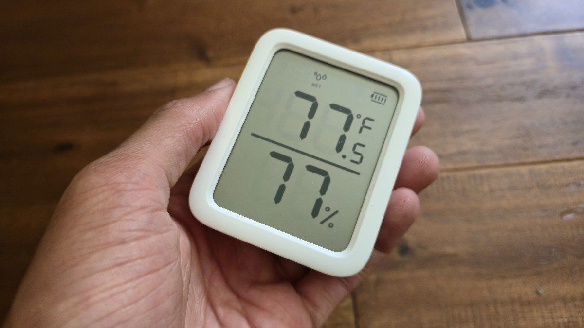 Hand holding a switchbot meter plus