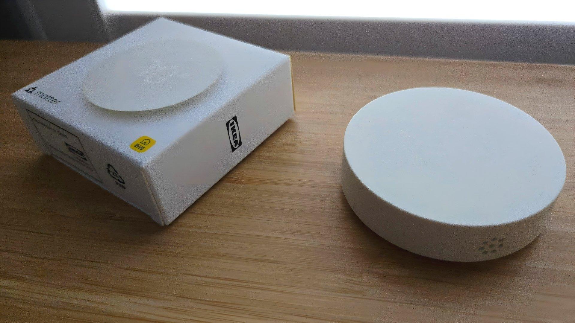 Ikea timmerflotte temperature and humidity sensor next to its box Ikea timmerflotte temperature and humidity sensor next to its box